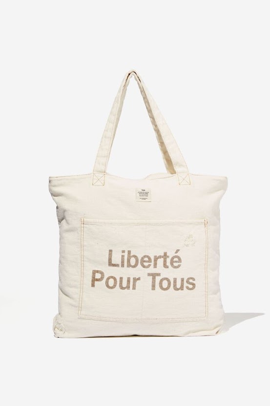 A tote bag from Typo with the text Liberté Pour Tous on it.