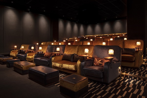 Inside of movie theatre showing sofas instead of traditional chairs